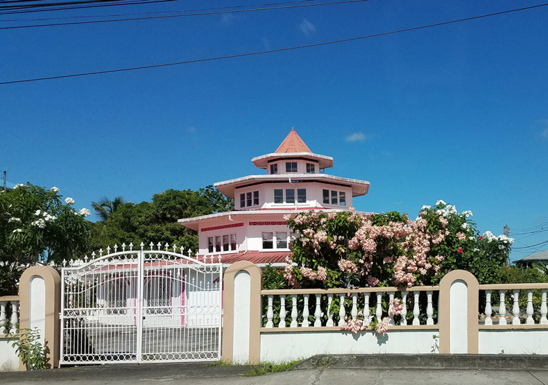 Local color: pink domed house with pink flowers and white gate