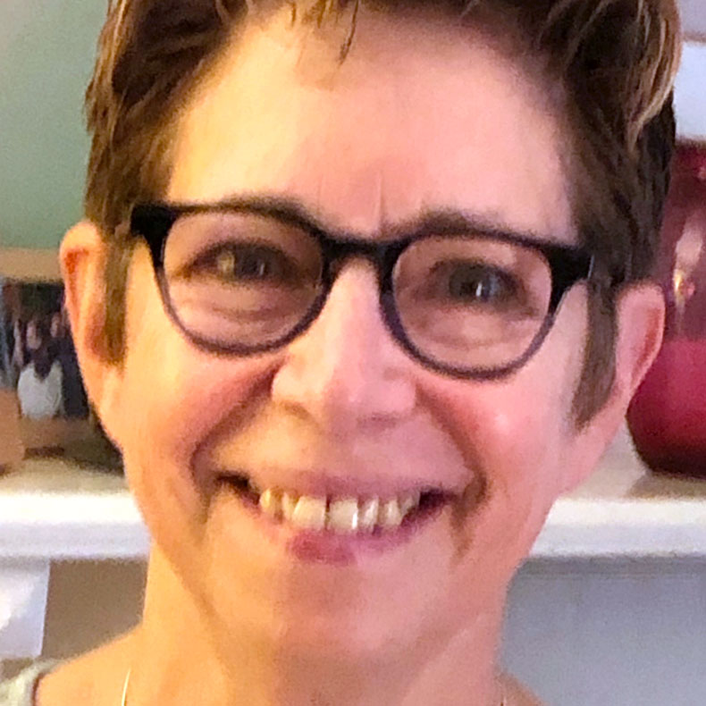Head shot of smiling woman wearing glasses