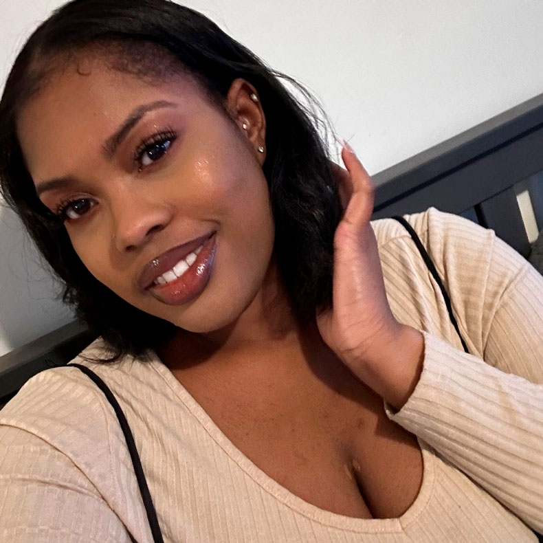 Close up portrait photo of Aiisha wearing a tan top