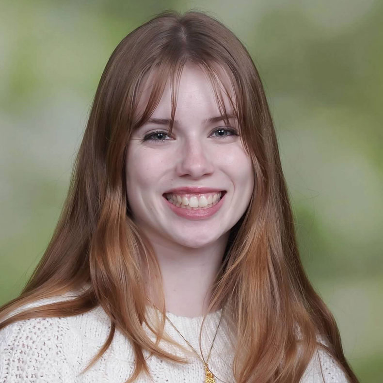 Profile photo of Anna Filoso smiling in white sweater and light green background