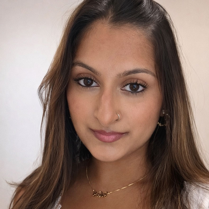 Profile photo of smiling woman with long brown hair on neutral background