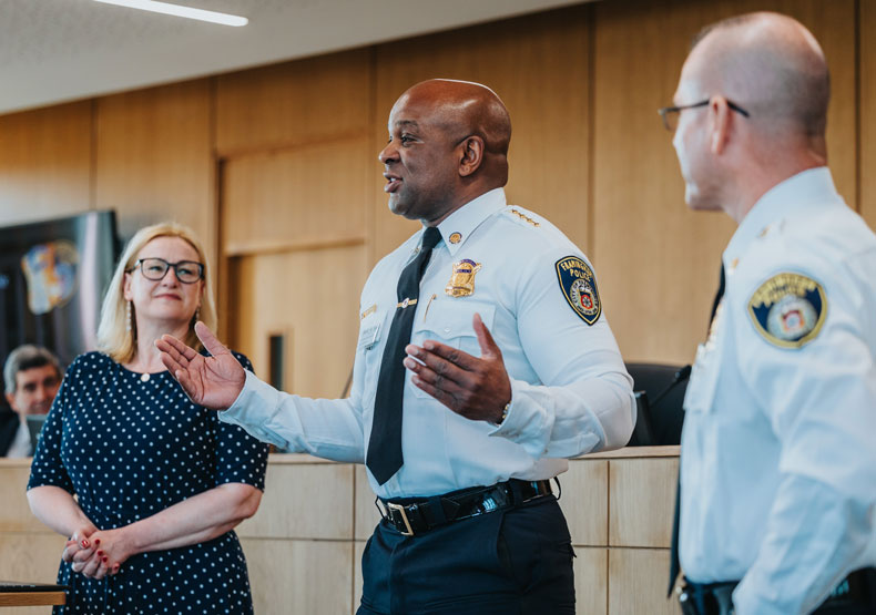 woman and two police officers making presentatin