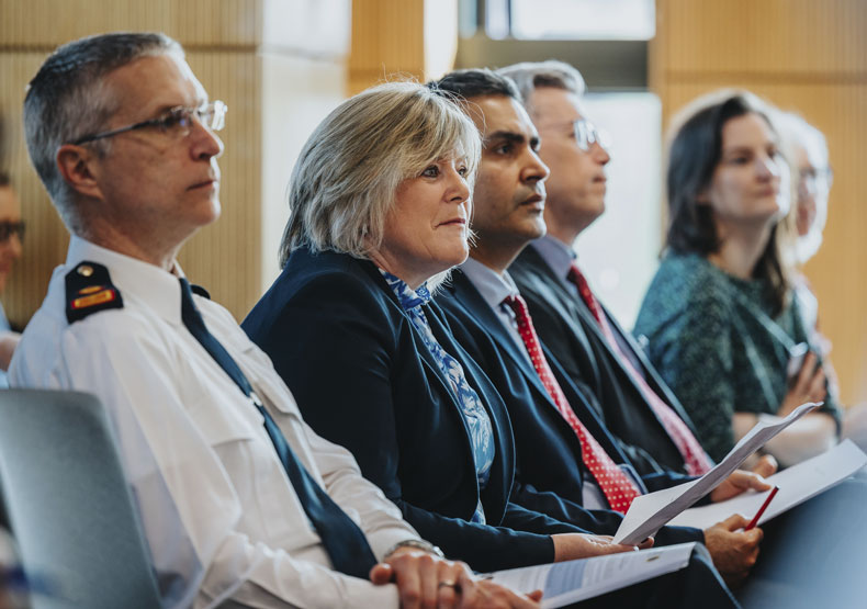 group of people seated listening to presentation