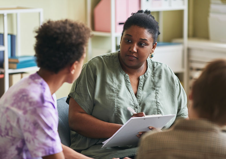 female teacher and counselor talking with child