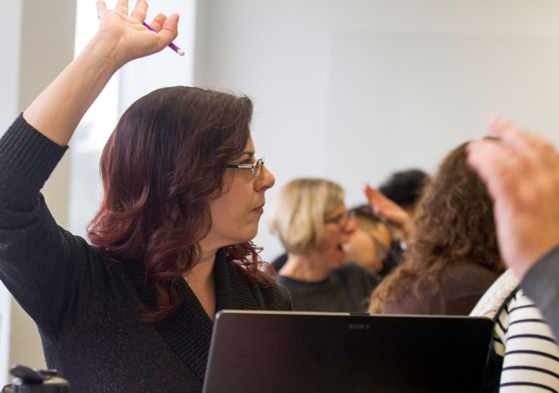 Woman in class with raised hand