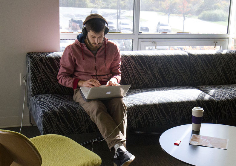 Student studying in campus lounge