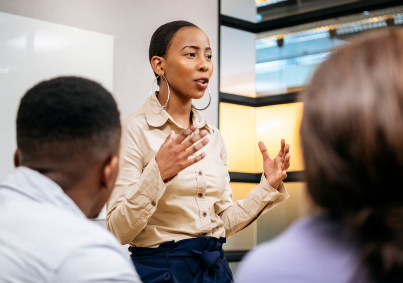 black female speaking to other professionals