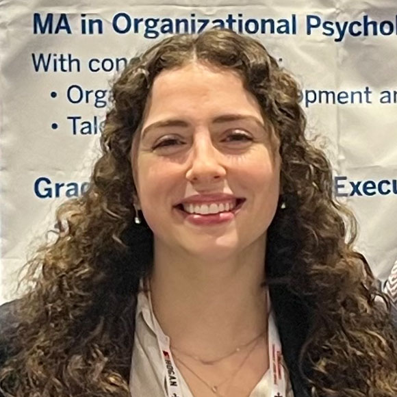 Close up of woman in front of an exhibit poster