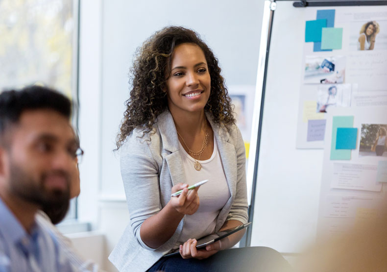 woman in front of presentation board