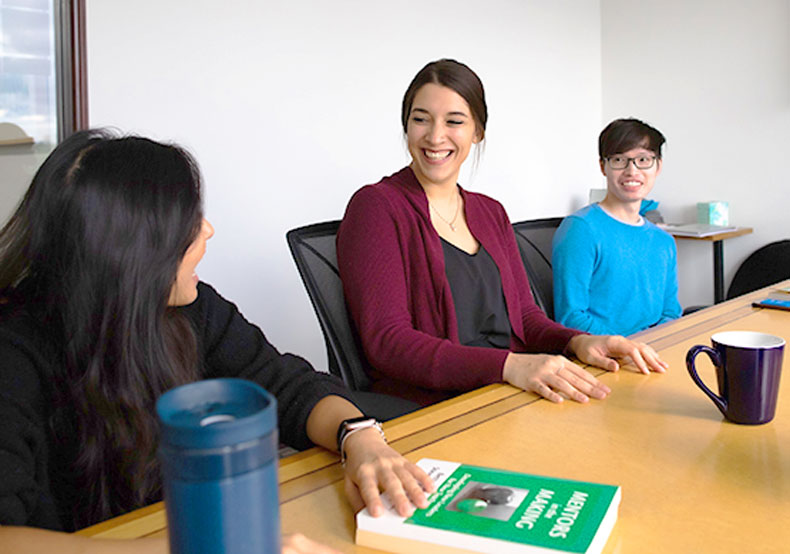 three people meeting at table