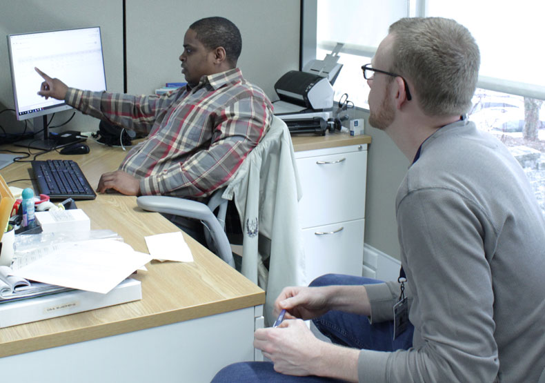 two males in an office working