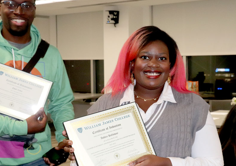 Photo of woman holding a diploma in a classroom