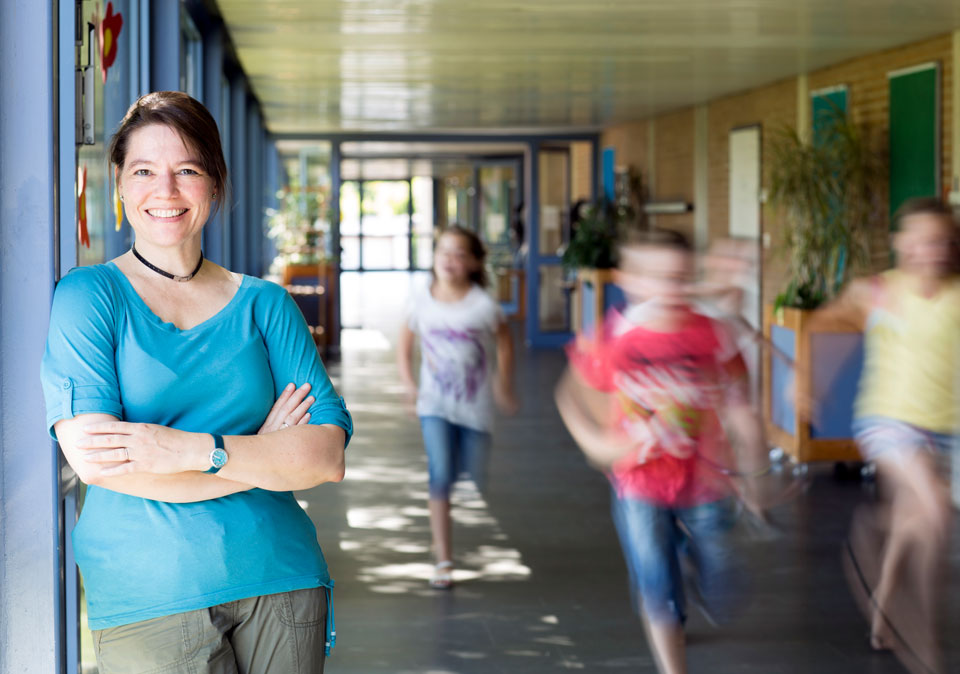 Teacher smiling in school hallway