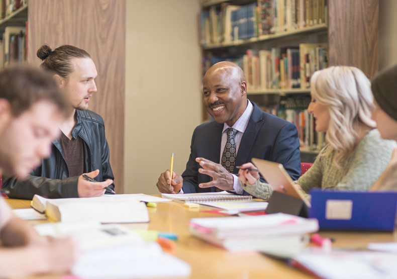 Group of adults at a table in a library setting