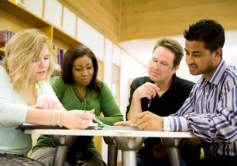 Group of adults at a table in a library setting