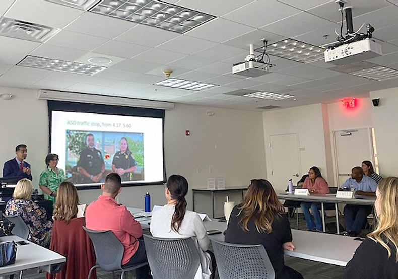 classroom of adults looking at presentation screen