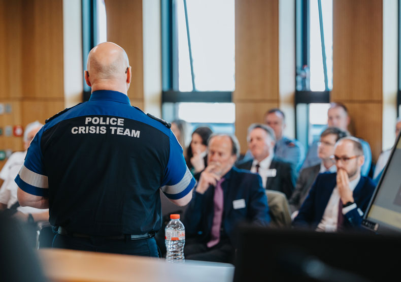 Crisis response police officer speaking to group