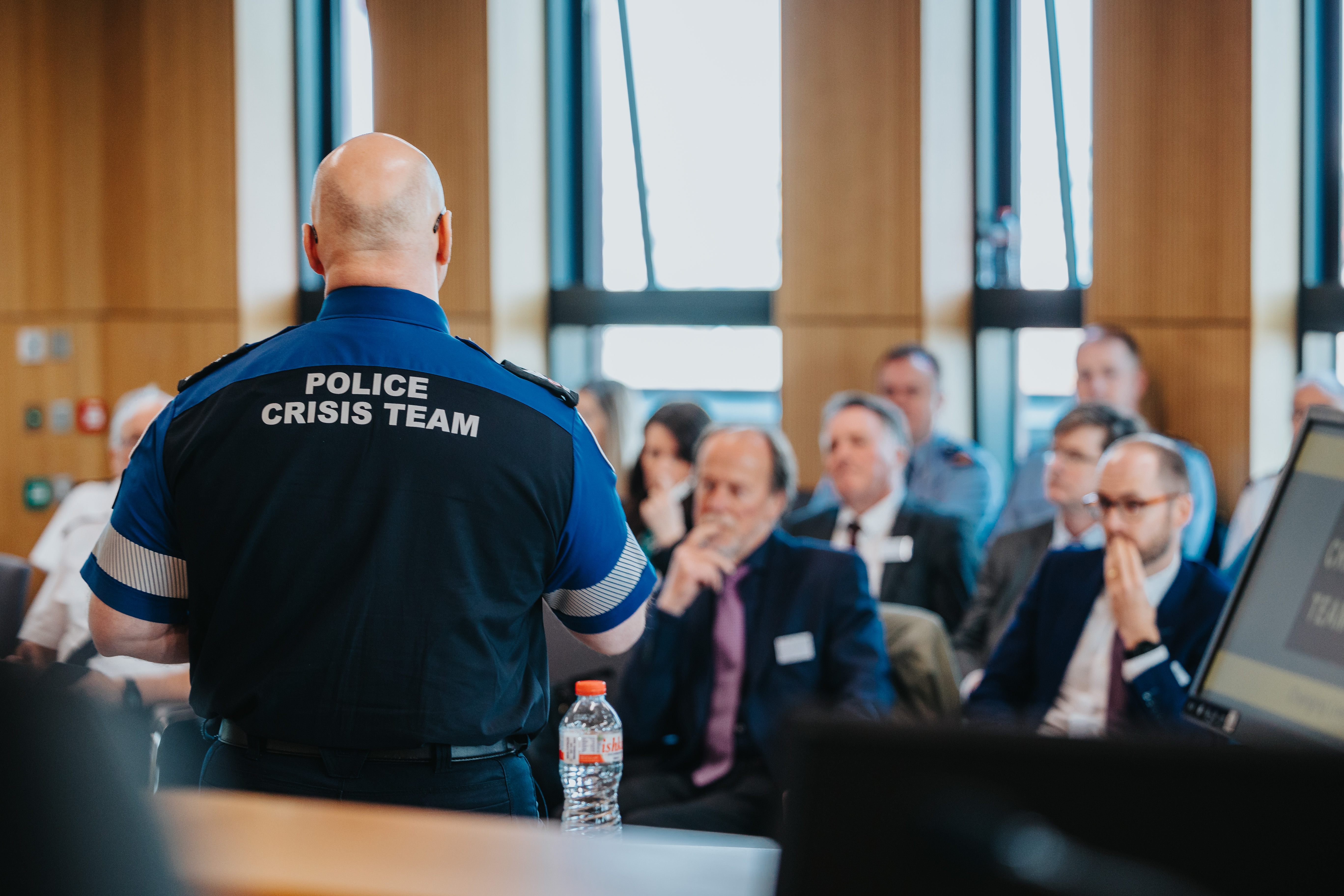 Police officer presents at an international co-response meeting