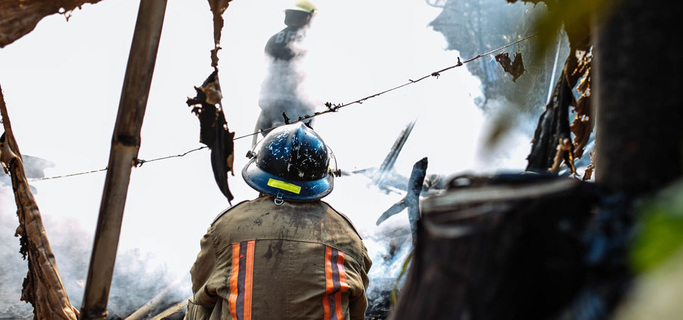 photo of fireman investigating scene after fire is out