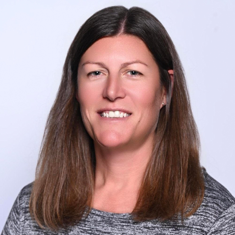 profile photo of woman with long hair and light blue background