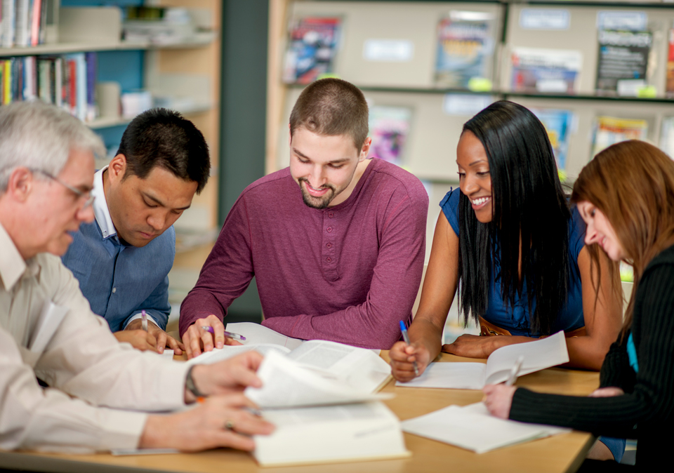 diverse group of adults working at a table