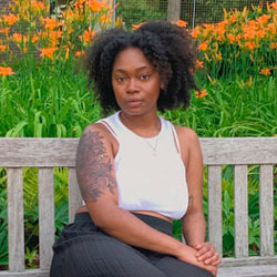 Olivia Fenty Olivia Fenty sitting on a bench in a garden