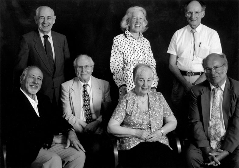 black and white photo of group of men and woman posing