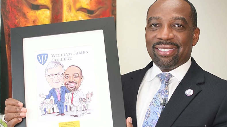 A man holding a personalized drawing of him with another person