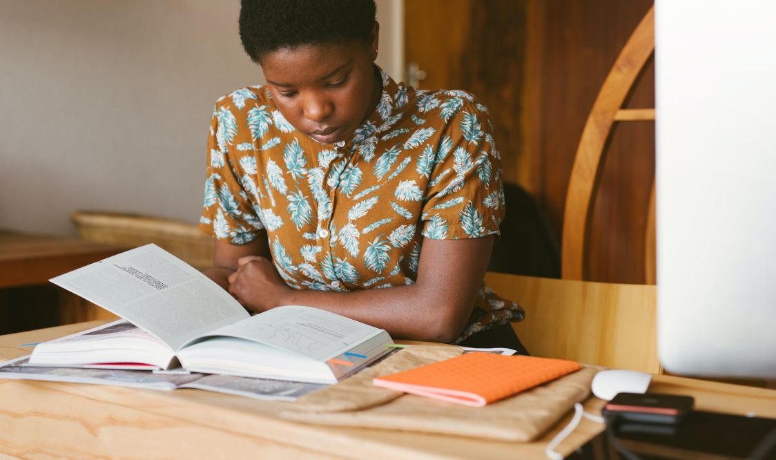 Photo of person reading a textbook