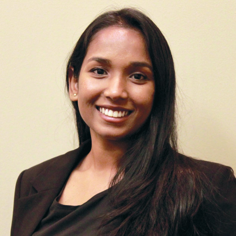 Ananya Ruth Samuel Portrait photo of smiling woman, with long brown hair and dark top