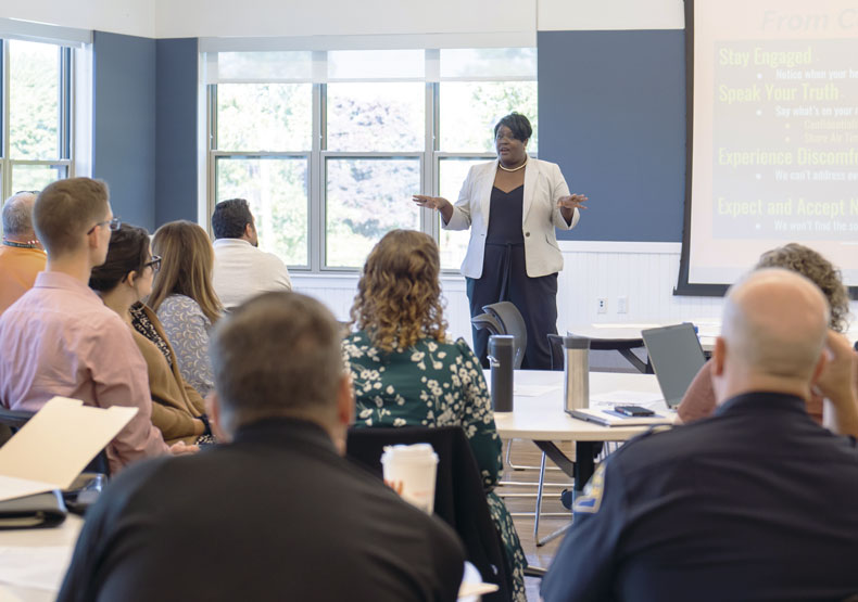 Photo of Dr. Kris Taylor leads a session on racial equity for the town of Needham.