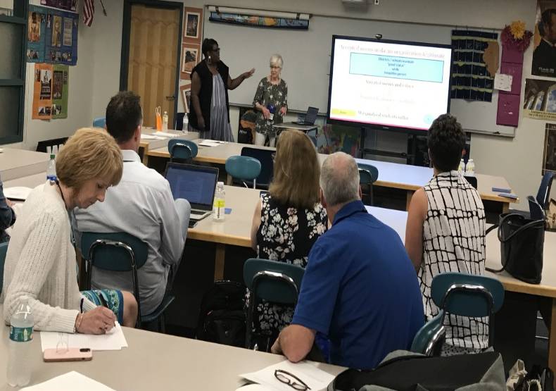 Dr. Kris Taylor presents to a classroom