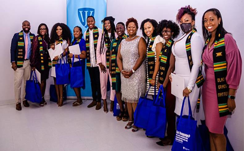 Graduating members of the first cohort of Scholars to join the Black Mental Health Graduate Academy with Dr. Natalie Cort (Center) at a fall celebration. [Photo: Conway King]
