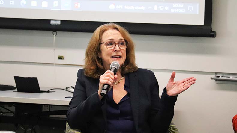 Dr. Nancy Connolly speaking into a microphone