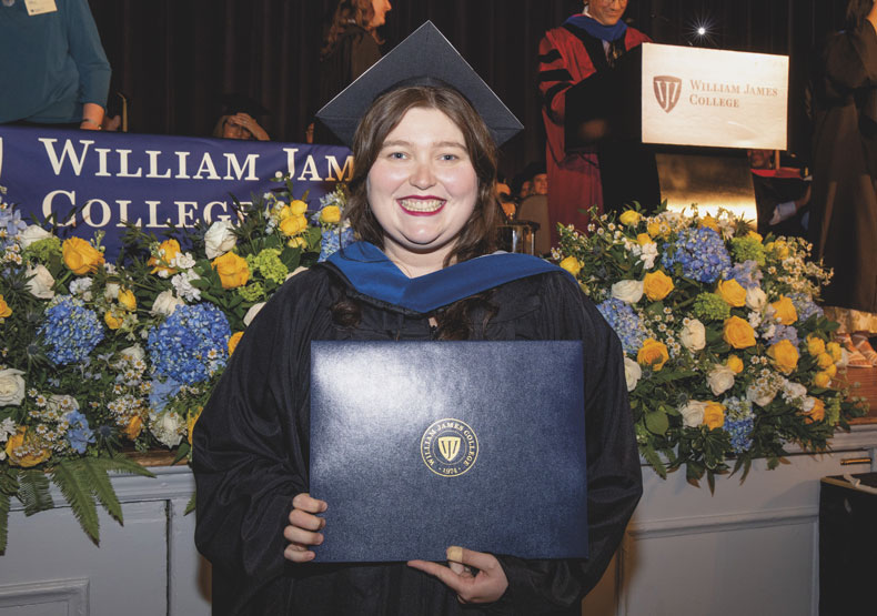 Photo of Elisa Huerta in cap and gown holding diploma