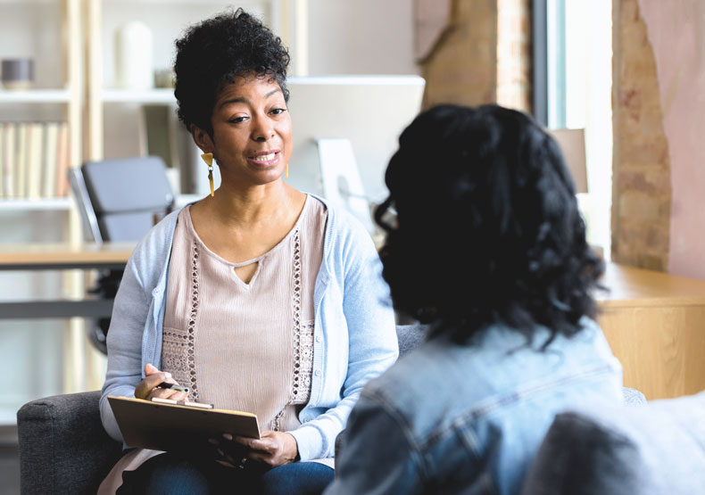 woman counselor talking with a patient