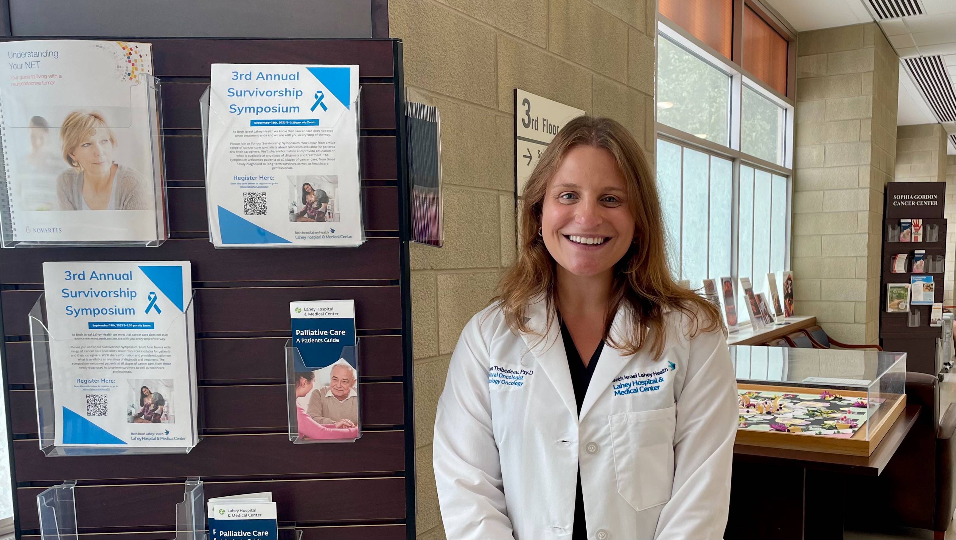 Photo of alumna Kathryn Thibedeau in a white Lahey Hospital coat