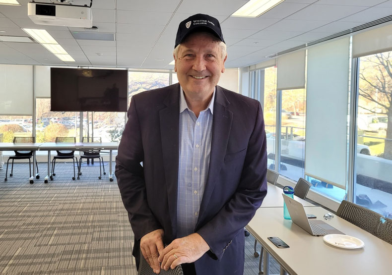 man with hat on in front of classroom
