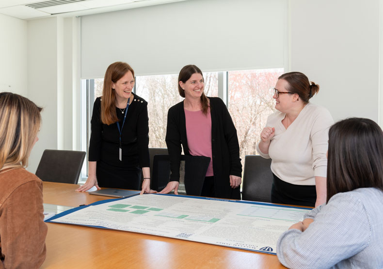 group in front of a poster