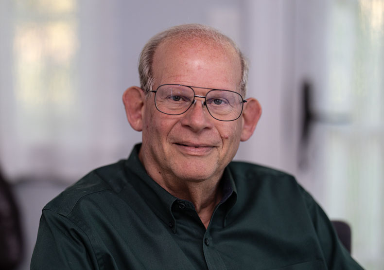 Portrait photo of older adult male in glasses