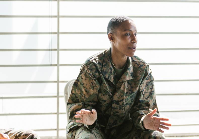 Woman in uniform speaking to a group.