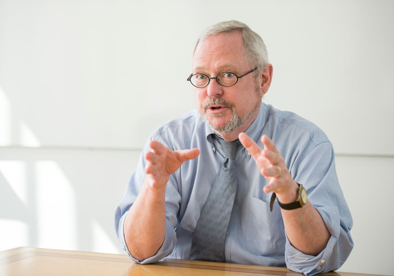 professor talking at table