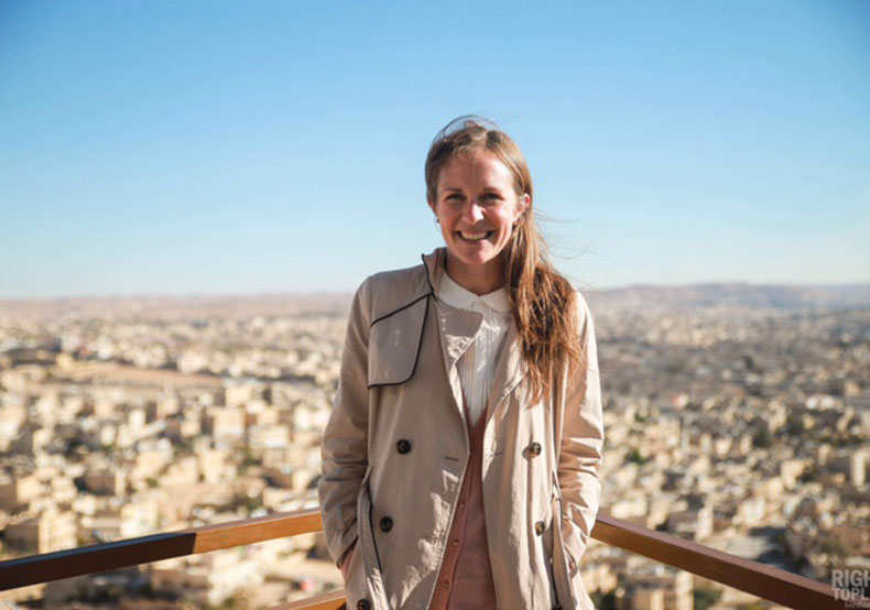 woman standing in front of city