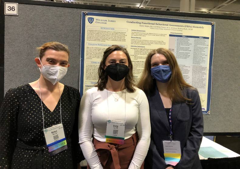 Dr. Robyn Bratica, Emily Sieple, and Olivia Tyson pose in front of their poster