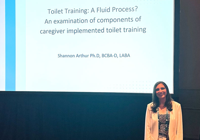 woman in front of powerpoint screen