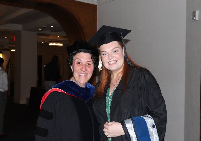 Colleen Deely posing with Dr. Jess Stahl at graduation.