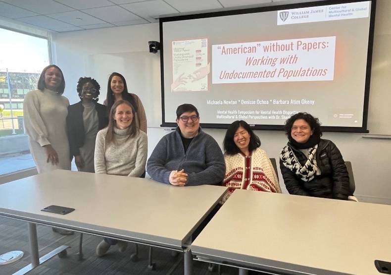 Students and panelists pose for a group picture at the symposium.