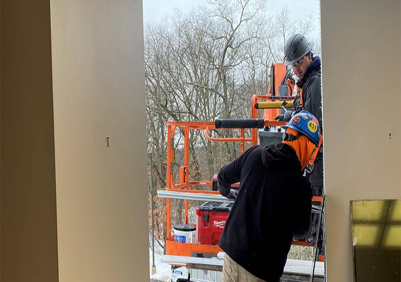 Construction crew members removed windows in Room 207.