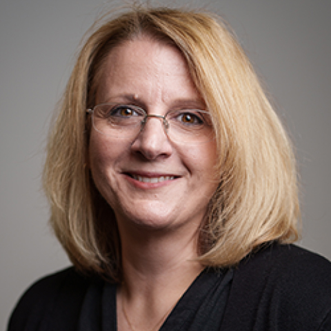 Profile photo of smiling woman in glasses with blonde hair