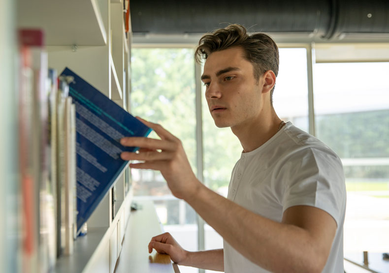 student in library